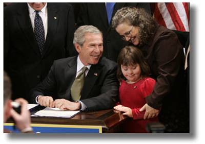 Over the years, President Bush has supported a number of programs and laws related to disability. In this 2004 picture, he chats with a mother and daughter before signing the Individuals with Disabilities Education Act (IDEA).